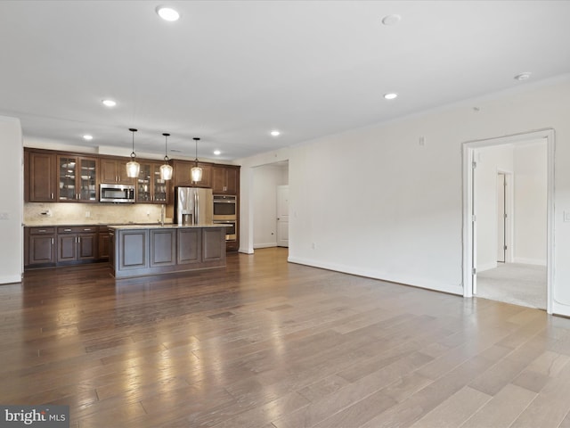 unfurnished living room featuring sink and wood-type flooring