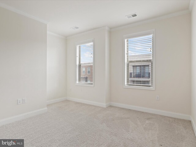 unfurnished bedroom with a walk in closet, a closet, ensuite bathroom, carpet floors, and crown molding