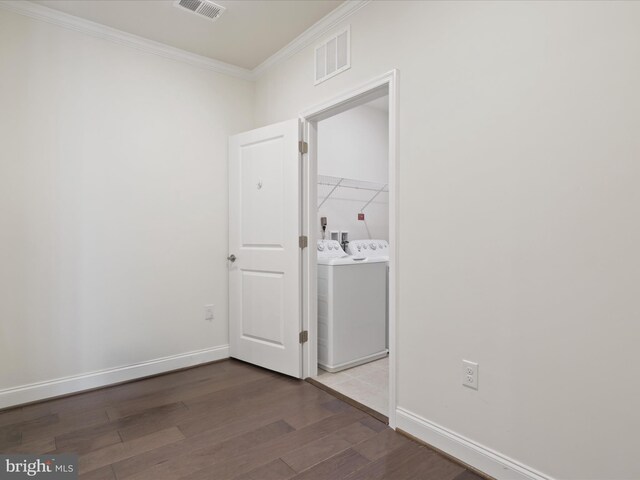 empty room featuring hardwood / wood-style floors and crown molding