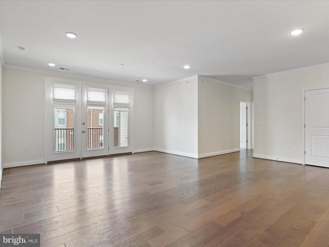 spare room featuring crown molding, hardwood / wood-style flooring, and french doors