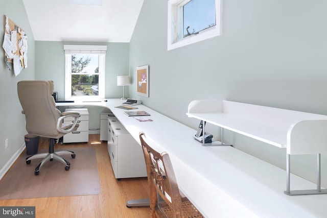 office space with light wood-type flooring and built in study area