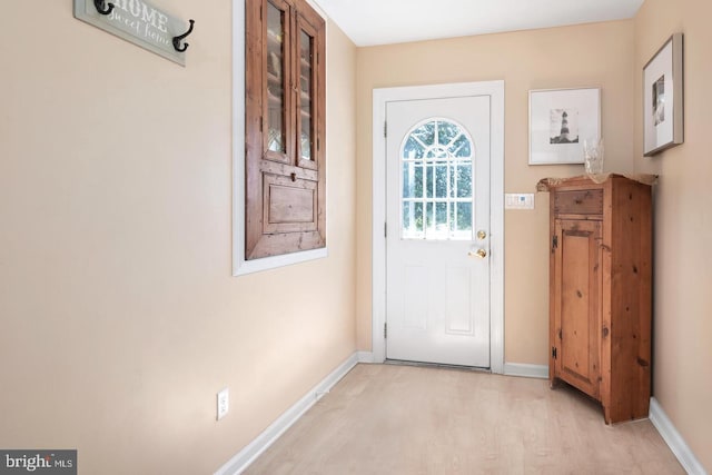 doorway to outside featuring light wood-style floors and baseboards