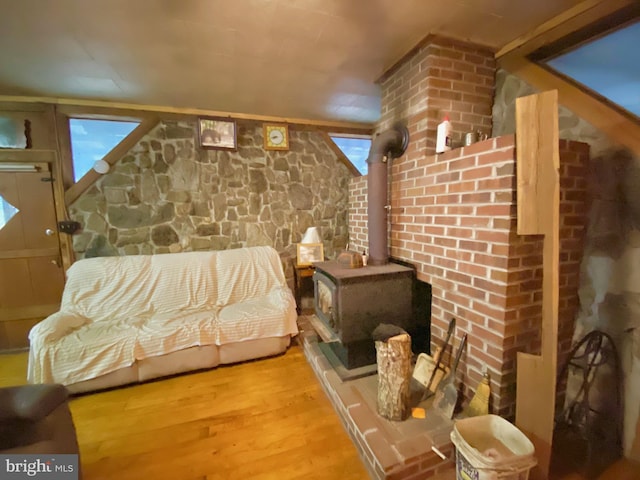 interior space featuring wood finished floors and a wood stove