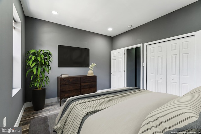 bedroom with a closet and hardwood / wood-style flooring