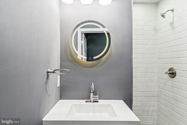 bathroom featuring sink and tiled shower