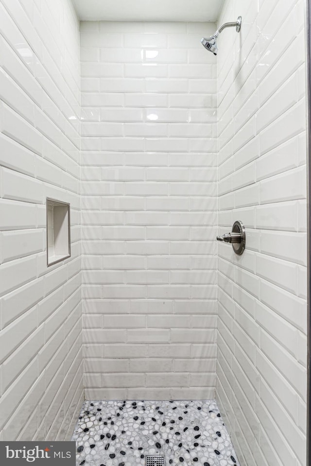 bathroom with tiled shower