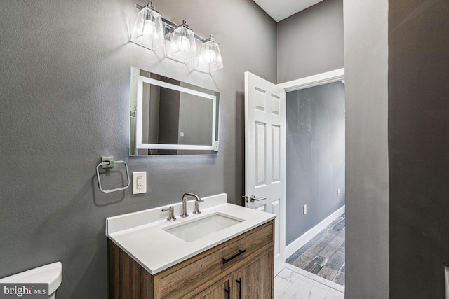 bathroom featuring vanity and toilet