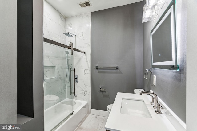 full bathroom featuring combined bath / shower with glass door, vanity, and toilet