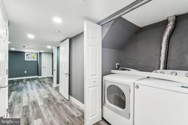 washroom featuring independent washer and dryer and light hardwood / wood-style flooring