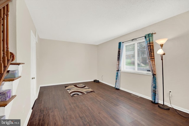 spare room with dark hardwood / wood-style floors