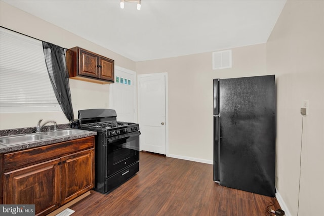 kitchen featuring sink, dark hardwood / wood-style flooring, and black appliances