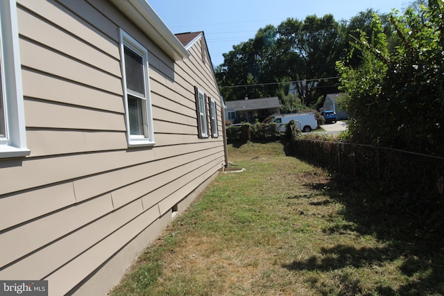 view of property exterior with a yard