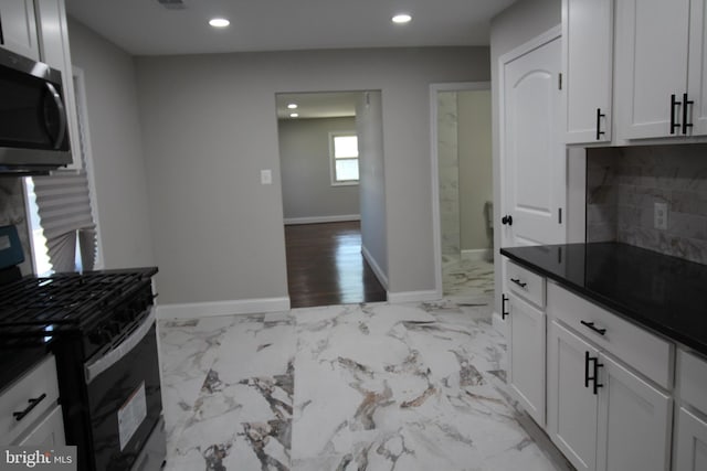 kitchen featuring tasteful backsplash, stainless steel appliances, and white cabinets