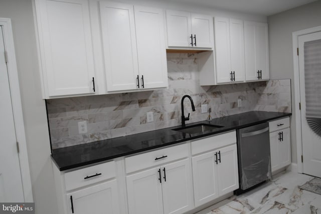 kitchen featuring a sink, dark countertops, white cabinets, and stainless steel dishwasher