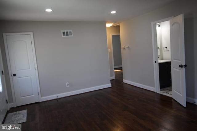 unfurnished room with dark wood-style floors, recessed lighting, visible vents, and baseboards