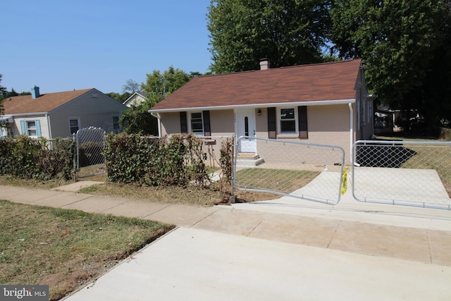 view of front of home featuring a fenced front yard, a gate, and brick siding