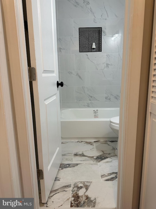 full bathroom with toilet and marble finish floor