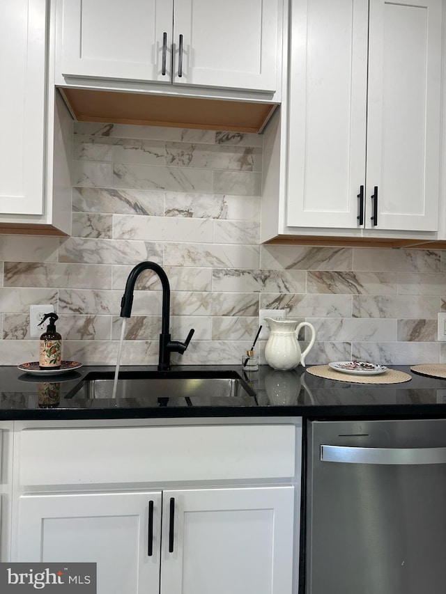 kitchen with tasteful backsplash, dark stone counters, sink, dishwasher, and white cabinets