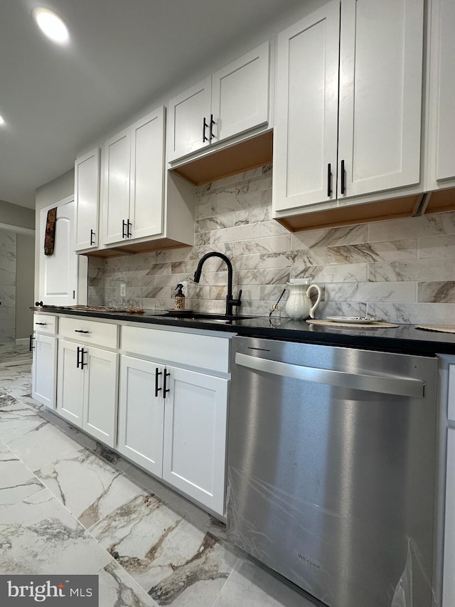 kitchen featuring marble finish floor, white cabinets, and stainless steel dishwasher