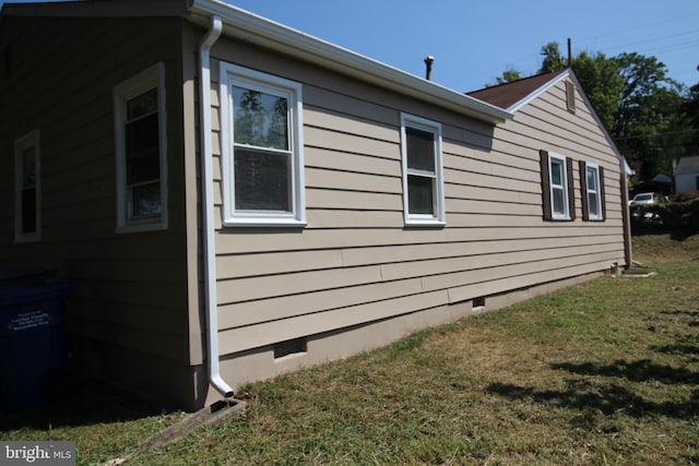 view of property exterior with crawl space and a yard