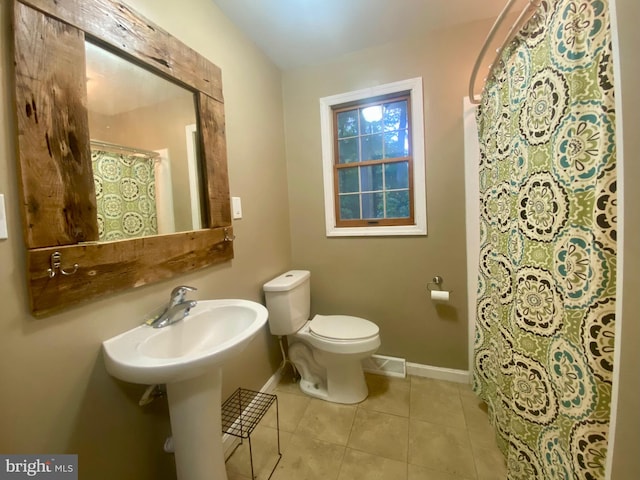 bathroom featuring toilet and tile patterned floors