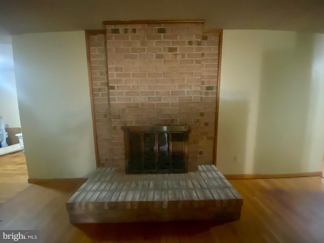 details featuring a fireplace and hardwood / wood-style flooring