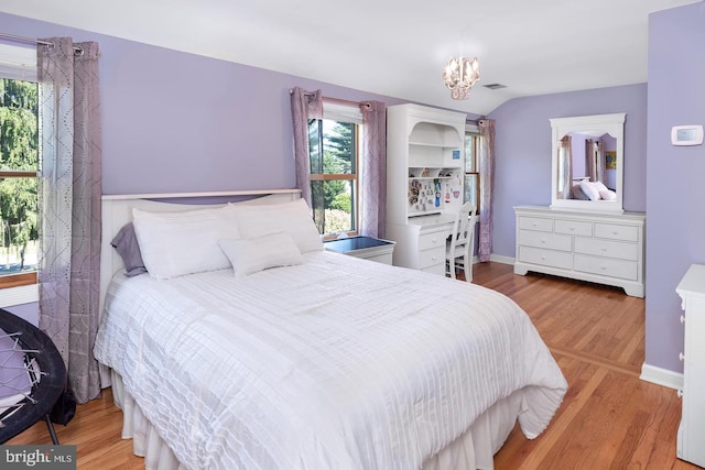 bedroom featuring light hardwood / wood-style flooring and multiple windows