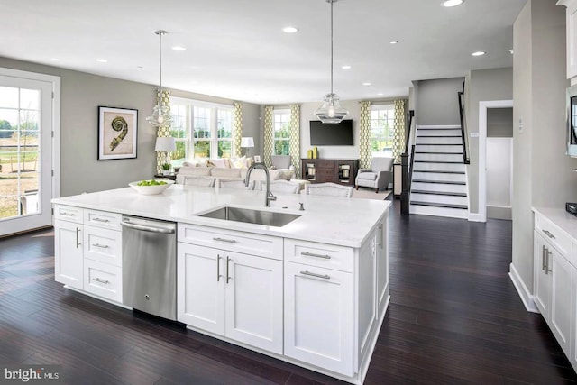 kitchen with sink, dark hardwood / wood-style flooring, a center island with sink, and dishwasher