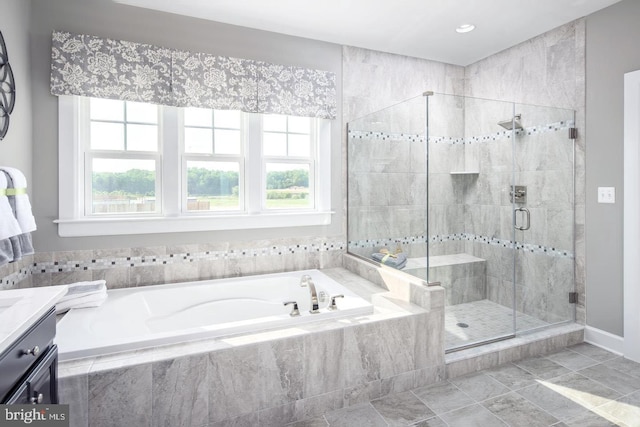 bathroom featuring independent shower and bath, vanity, and tile patterned floors