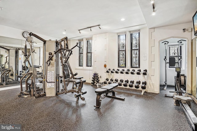 gym featuring rail lighting and recessed lighting