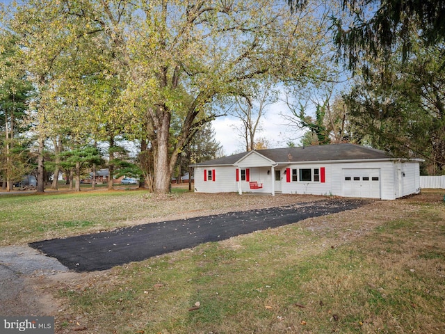 view of front of home with a garage and a front lawn