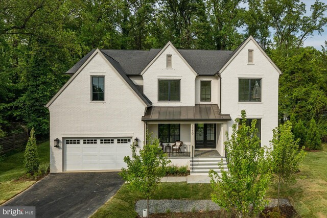 view of front of house with a garage and a porch