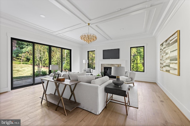 living room with a premium fireplace, coffered ceiling, light hardwood / wood-style flooring, and a healthy amount of sunlight