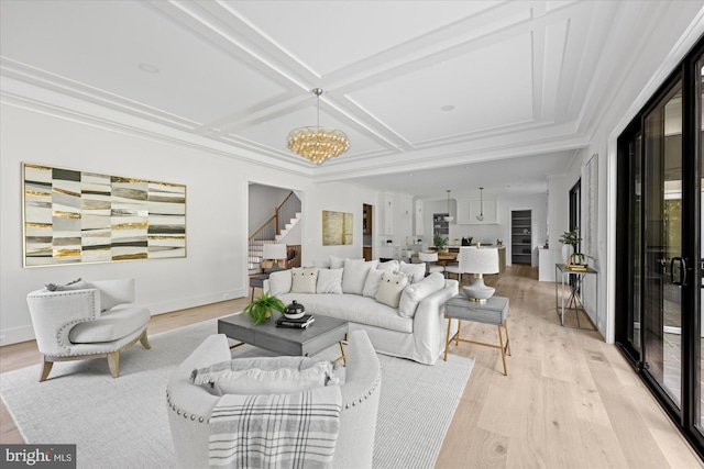 living room featuring coffered ceiling, light hardwood / wood-style flooring, crown molding, and a chandelier