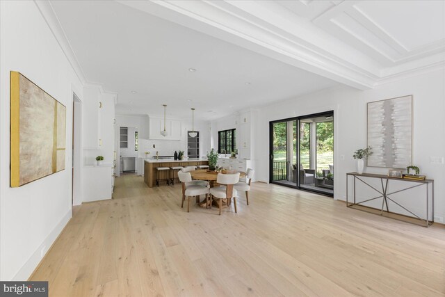 dining space featuring light hardwood / wood-style flooring and ornamental molding