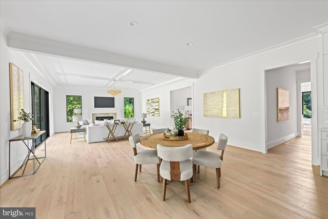 dining area featuring light wood-type flooring, beamed ceiling, crown molding, and coffered ceiling