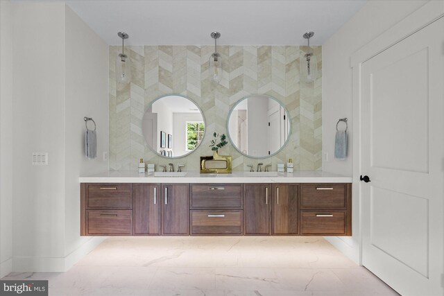 bathroom with tile patterned flooring, a tile shower, and vanity