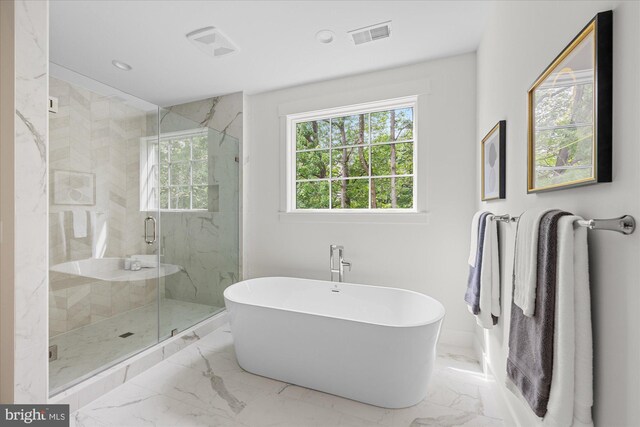 bathroom with tile patterned floors and separate shower and tub