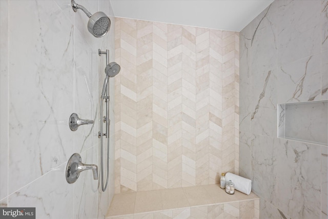 bathroom with a tile shower