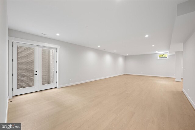 unfurnished room featuring light hardwood / wood-style floors and french doors