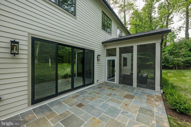 view of patio featuring a sunroom