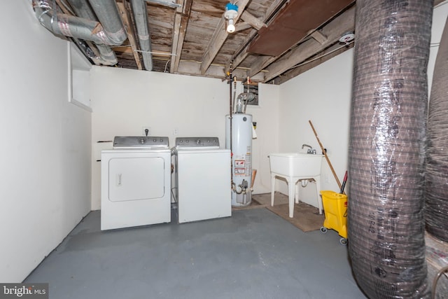 laundry area with gas water heater and separate washer and dryer