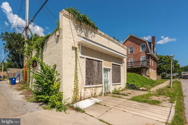 view of side of property featuring brick siding