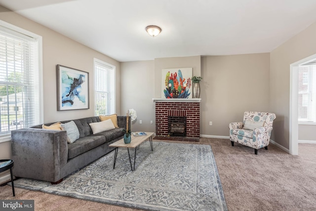 living room featuring a wealth of natural light, a fireplace, baseboards, and carpet flooring