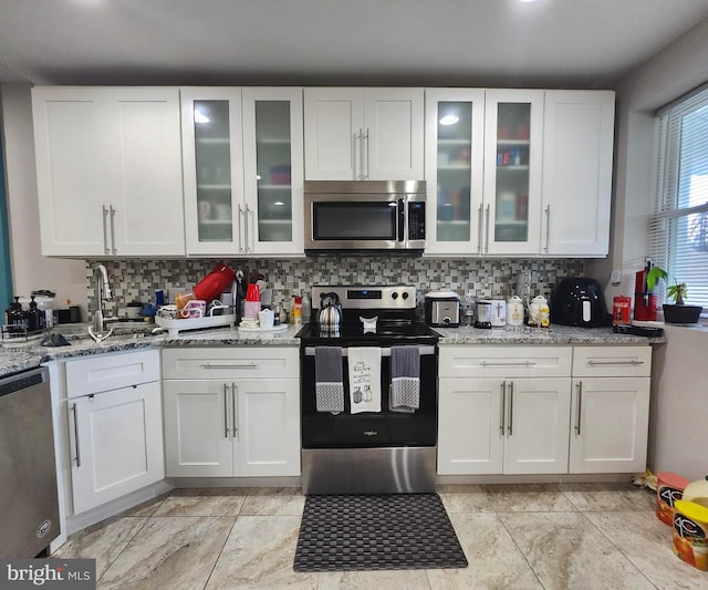 kitchen with appliances with stainless steel finishes and white cabinetry