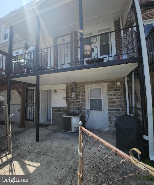 back of property featuring central AC unit