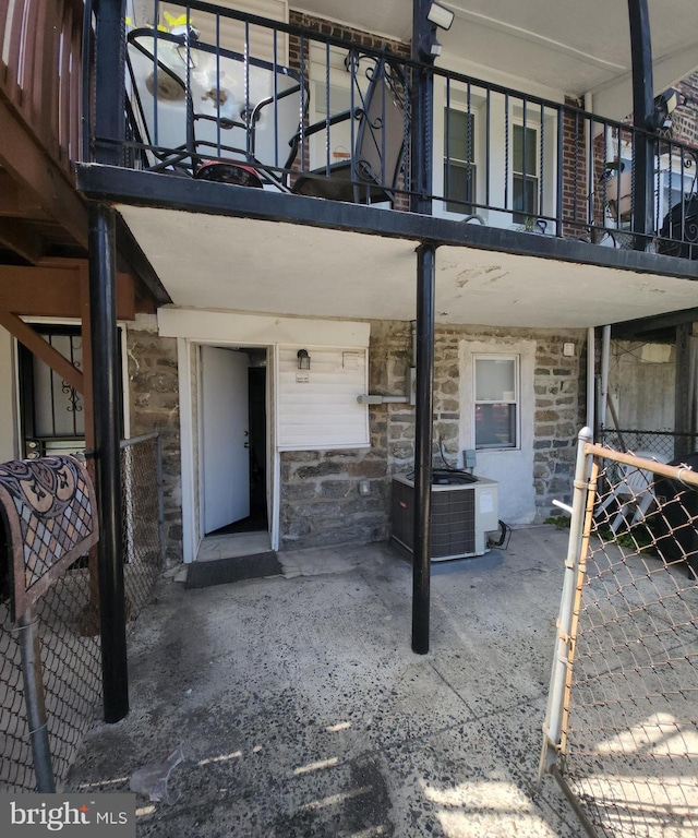 doorway to property with a balcony and central AC