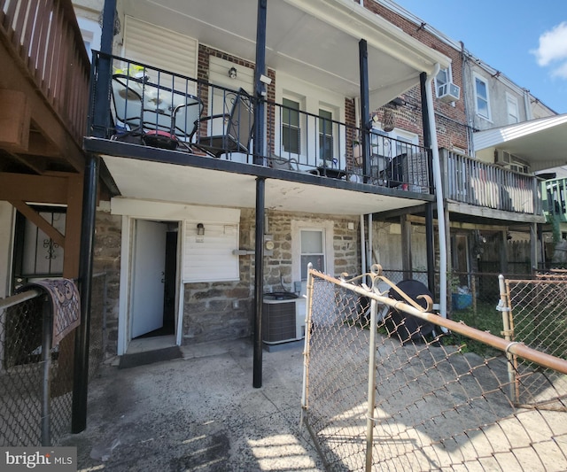 exterior space with a balcony and central AC unit