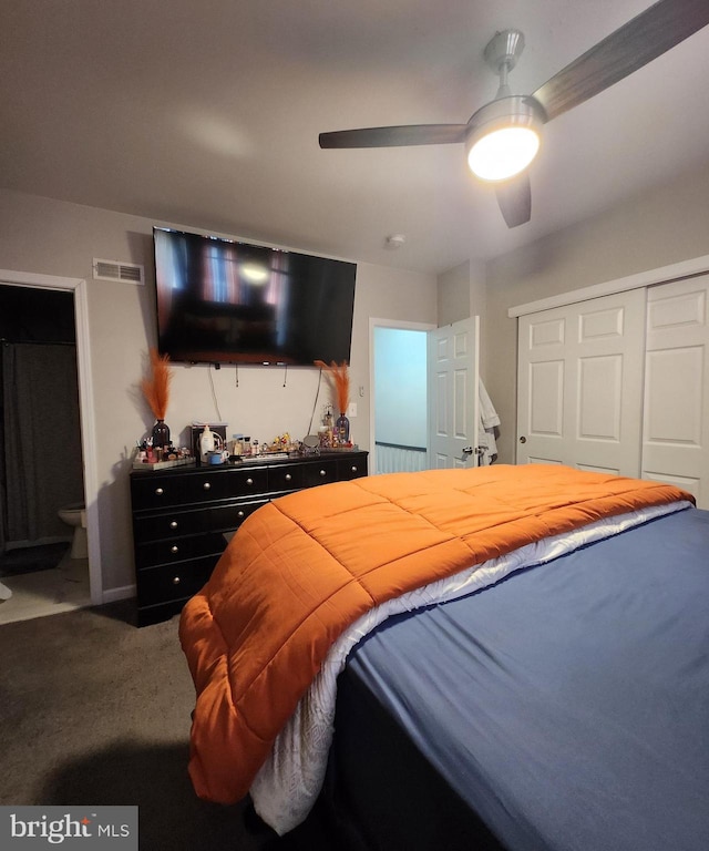 carpeted bedroom with ceiling fan, a closet, and ensuite bathroom