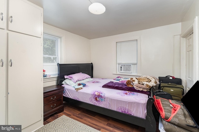 bedroom with hardwood / wood-style floors and cooling unit